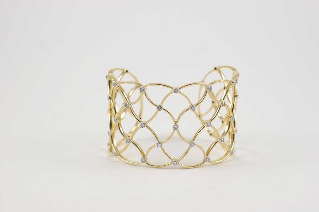 18kt Yellow Gold Woven Cuff with 47 Diamonds set in Platinum ~1.88cts.

The diamonds weigh approximately 2 carats of diamonds

The measurement top to bottom is 1.75 inches.

The bracelet measure 6.75